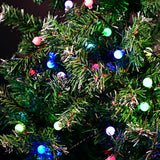 LYYT 20m multicoloured berry string lights illuminating a green artificial Christmas tree with pink, blue, green and white LED globes.