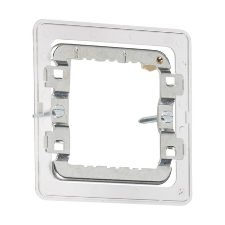 Introducing the 1-2 Gang Grid Mounting Frame For Screwless: a rectangular mounting bracket made from premium-grade steel and plastic, designed with a clear frame. It includes two adjustable screws, perfect for securing electrical outlets or switches. The screwless grid faceplates provide a smooth, seamless appearance against any plain white background.