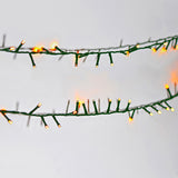 Close-up of the LYYT 45m amber LED string lights showing densely clustered warm amber bulbs along a green cable against a white background.