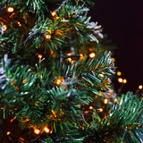 LYYT 45m amber LED string lights glowing warmly across a green Christmas tree with frosted tips at night.