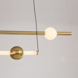 The Sottile LED Horizontal Suspension Light - Gold features a minimalist design with brass rods and spherical elements—one glowing white, one metallic—suspended by thin wires for a bold modern statement.