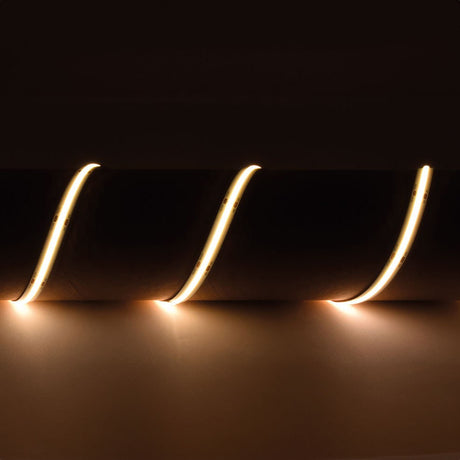 LYYT 24V COB LED strip light by AVSL shown in three curved sections emitting continuous 3000K warm white light against a dark background.