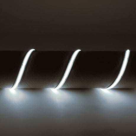 LYYT IP65 24V COB LED strip light by AVSL, 5m flexible tape wound around a cylindrical form, emitting cool white 6500K light against a dark background.