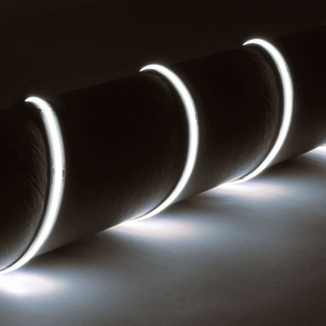 LYYT IP65 24V COB LED strip light by AVSL, coiled around a dark cylindrical form, emitting a continuous cool white 6500K glow along its flexible length.