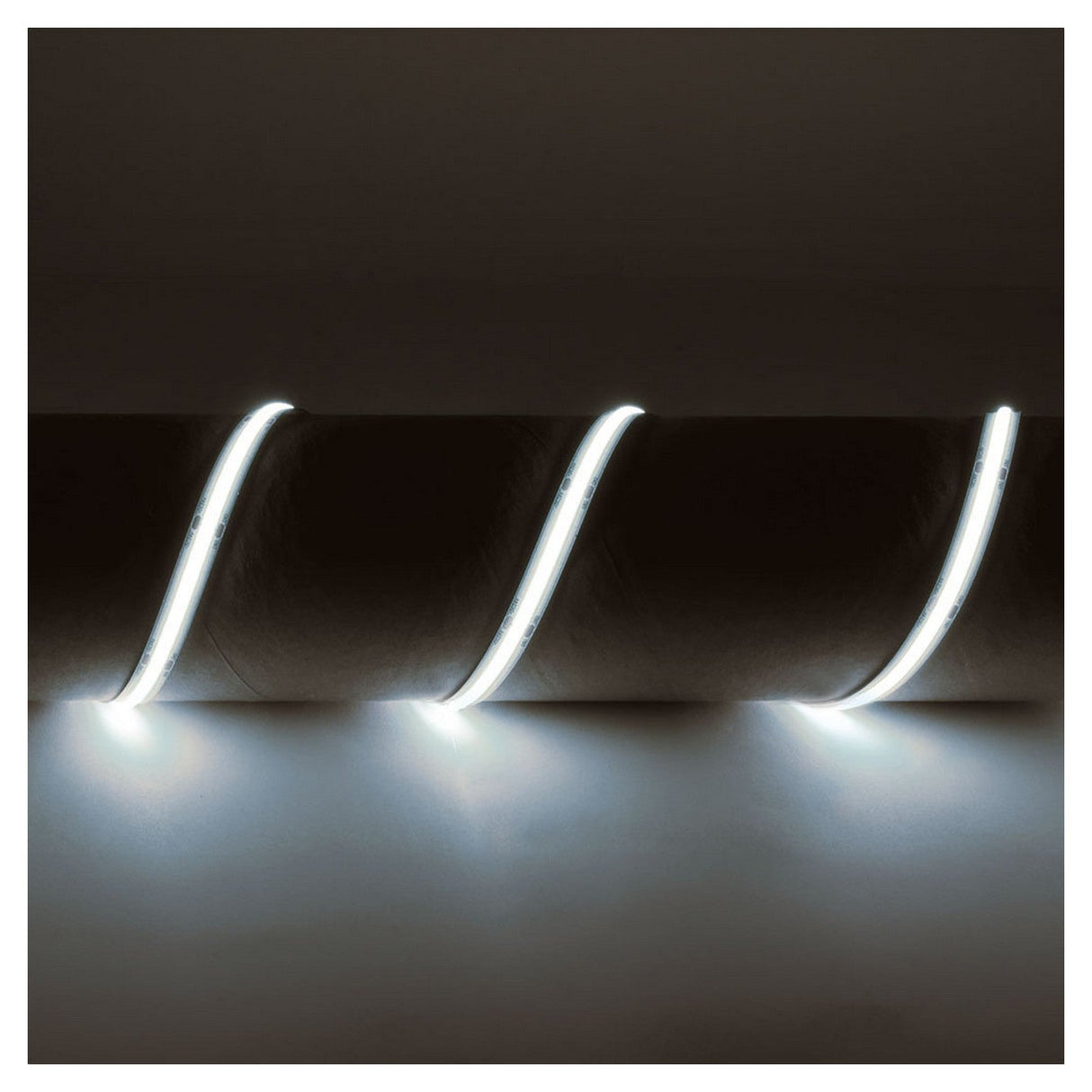 A close-up of the LYYT IP65 24V COB LED Strip Light 5m - 6500K showcases three glowing, curved lines. These seamless lighting elements emit a soft white light against the dark background.