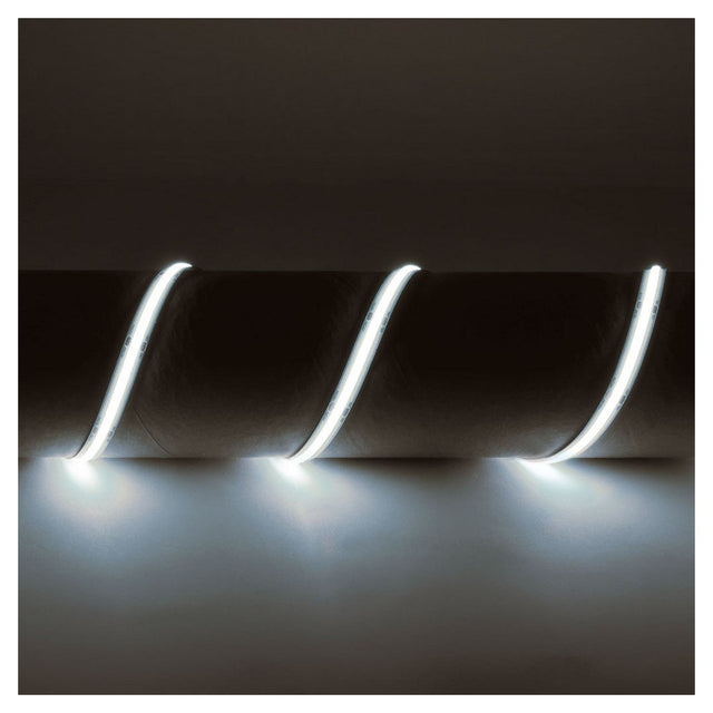 A close-up of the LYYT IP65 24V COB LED Strip Light 5m - 6500K showcases three glowing, curved lines. These seamless lighting elements emit a soft white light against the dark background.