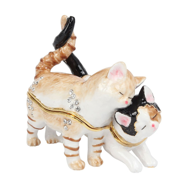 Hinged metal trinket box shaped as two cats nuzzling with twisted tails raised, one ginger and white tabby, the other white with a black patch and face markings, set on a plain white background.