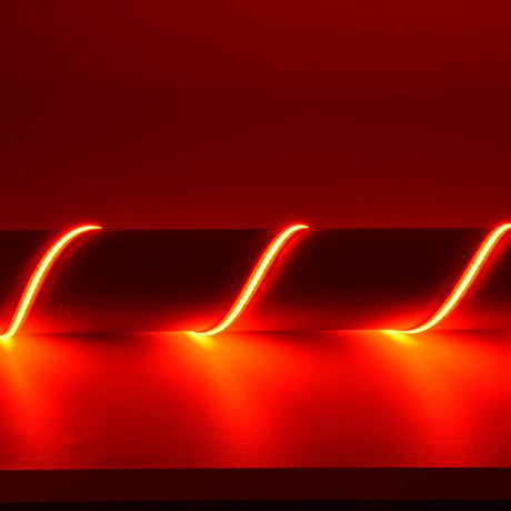 LYYT COB 24V RGB LED tape installed in a wavy pattern along a wall, glowing red with a continuous dot-free line of light.