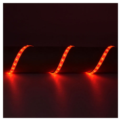 A dark room features the LYYT 12V LED Strip Light 5m - Red, with its super-bright LEDs illuminating in a vibrant red hue and creating a wavy pattern against a dark surface.