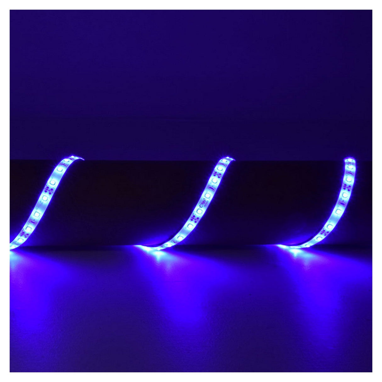 A close-up image features the LYYT 12V LED Strip Light 5m - Blue, celebrated for its energy efficiency and IP65 rating, arranged in a wavy pattern against a dark background. The vibrant blue illumination bathes the surroundings in light, producing a vivid and striking visual effect.