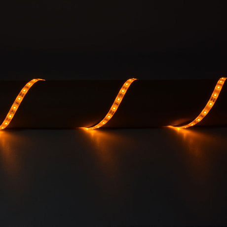 LYYT 12V Amber LED Strip Light draped in three curves over a cylindrical surface, glowing warm amber along the flexible IP65 tape against a dark background.