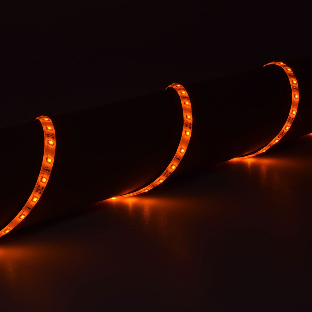 LYYT 12V amber LED strip light coiled around a surface, showing three loops of flexible IP65 tape glowing warm orange in a dark setting.