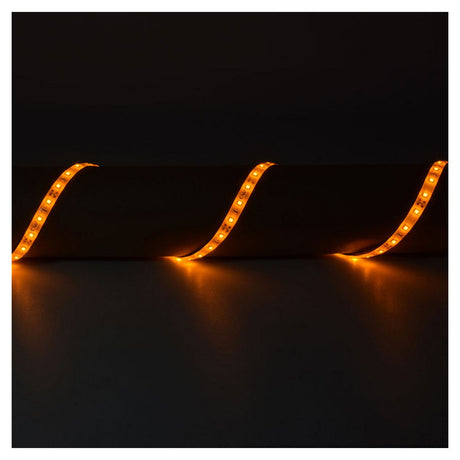 A dark room with LYYT 12V LED Strip Light 5m - Amber, featuring IP65-rated LED strips arranged in a wavy pattern, glowing in orange against a black background, emphasizing their low power consumption.