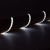 LYYT 12V SMD2835 LED strip light draped over a cylindrical surface, glowing cool white 6000K light along the flexible IP65 tape in a dark setting.
