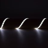 LYYT 12V SMD2835 LED strip light in 6000K cool white, arranged in three flowing curves on a dark surface, showing the flexible IP65 tape lit along its length.