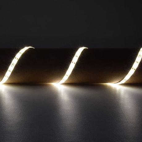 LYYT 5m warm white LED strip light by AVSL, draped in curved loops emitting 3000K glow against a dark grey backdrop.
