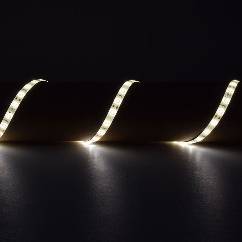 LYYT 12V SMD2835 LED strip light by AVSL, flexible warm white 3000K IP65 tape curving across a dark surface in a wave pattern.