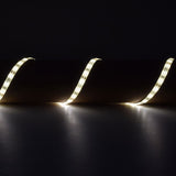 LYYT 12V SMD2835 LED strip light by AVSL, flexible warm white 3000K IP65 tape curving across a dark surface in a wave pattern.