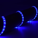 AVSL LYYT 12V RGB LED strip light illuminated in blue, wrapped around a dark cylindrical surface showing the flexible IP65 tape with evenly spaced LEDs.