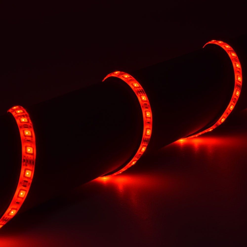AVSL LYYT 12V RGB LED strip light coiled in loops and glowing red against a dark background, showing the flexible IP65 tape with visible LEDs.