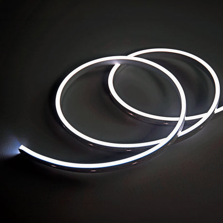LYYT SideBend CW 30m IP66 side bend LED tape by AVSL, coiled in loops and illuminated in cool white against a dark background.