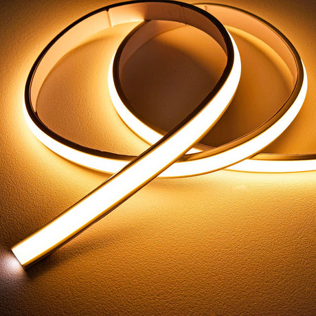 LYYT frosted warm white COB LED tape coiled and uncoiled, showing the domed silicone extrusion glowing evenly against a neutral surface.