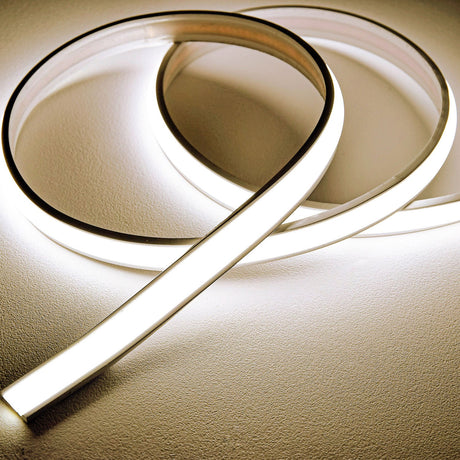 LYYT Frosted NW COB 24V IP66 Dome LED Tape coiled in loops, showing the slim domed silicone extrusion emitting a smooth natural white line of light.