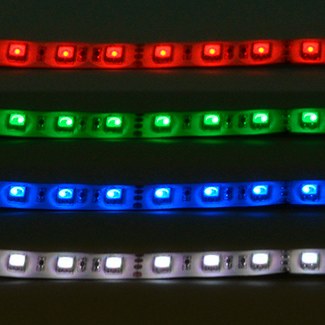 AVSL LYYT 24V RGB LED strip light shown in four segments illuminated red, green, blue, and white on a white silicone backing with IP65 coating.