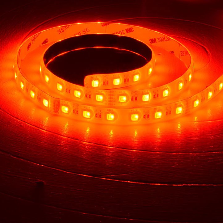 LYYT 24V RGBW LED strip light by AVSL, 5m reel coiled and illuminated in red, showing 60 LEDs per metre on IP65 silicone-coated tape with 3M adhesive backing.