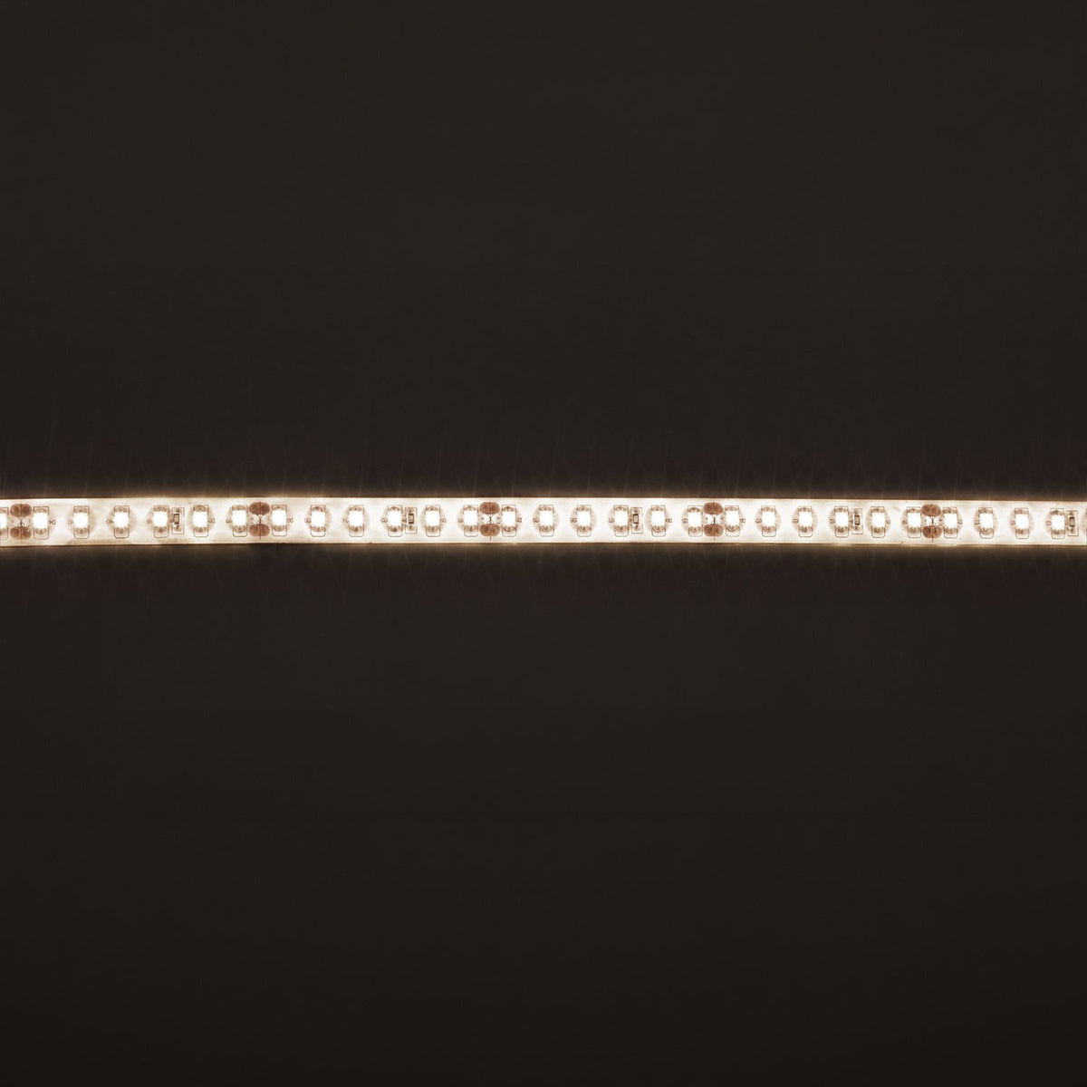 LYYT LT245120-NW LED strip tape illuminated in natural white, showing densely spaced LEDs along the silicone-coated IP65 strip against a dark background.