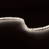 LYYT natural white IP65 LED strip illuminated in a curved S-shape against a black background, showing densely spaced SMD LEDs on silicone tape.