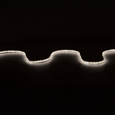 The LYYT 24V High Output LED Strip Light 5m - 4000K softly illuminates against a dark background, forming gentle curves across the image. This water-resistant LED light, with high luminous flux, casts a white glow that contrasts sharply with the black backdrop, showcasing its undulating design and ensuring easy installation anywhere.
