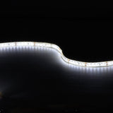 LYYT 24V high output LED strip light curved and illuminated in cool white 6000K against a black background, showing the flexible IP65 tape.