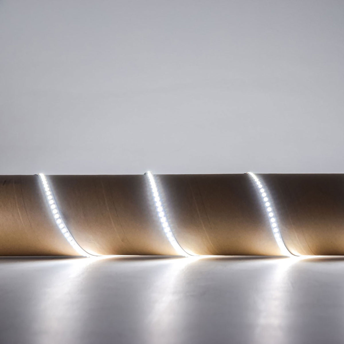 LYYT 24V high output LED strip light in 6000K cool white, shown illuminated and coiled to display the flexible tape with densely spaced SMD LEDs.