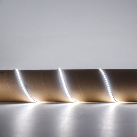 LYYT 24V high output LED strip light in 6000K cool white, shown illuminated and coiled to display the flexible tape with densely spaced SMD LEDs.