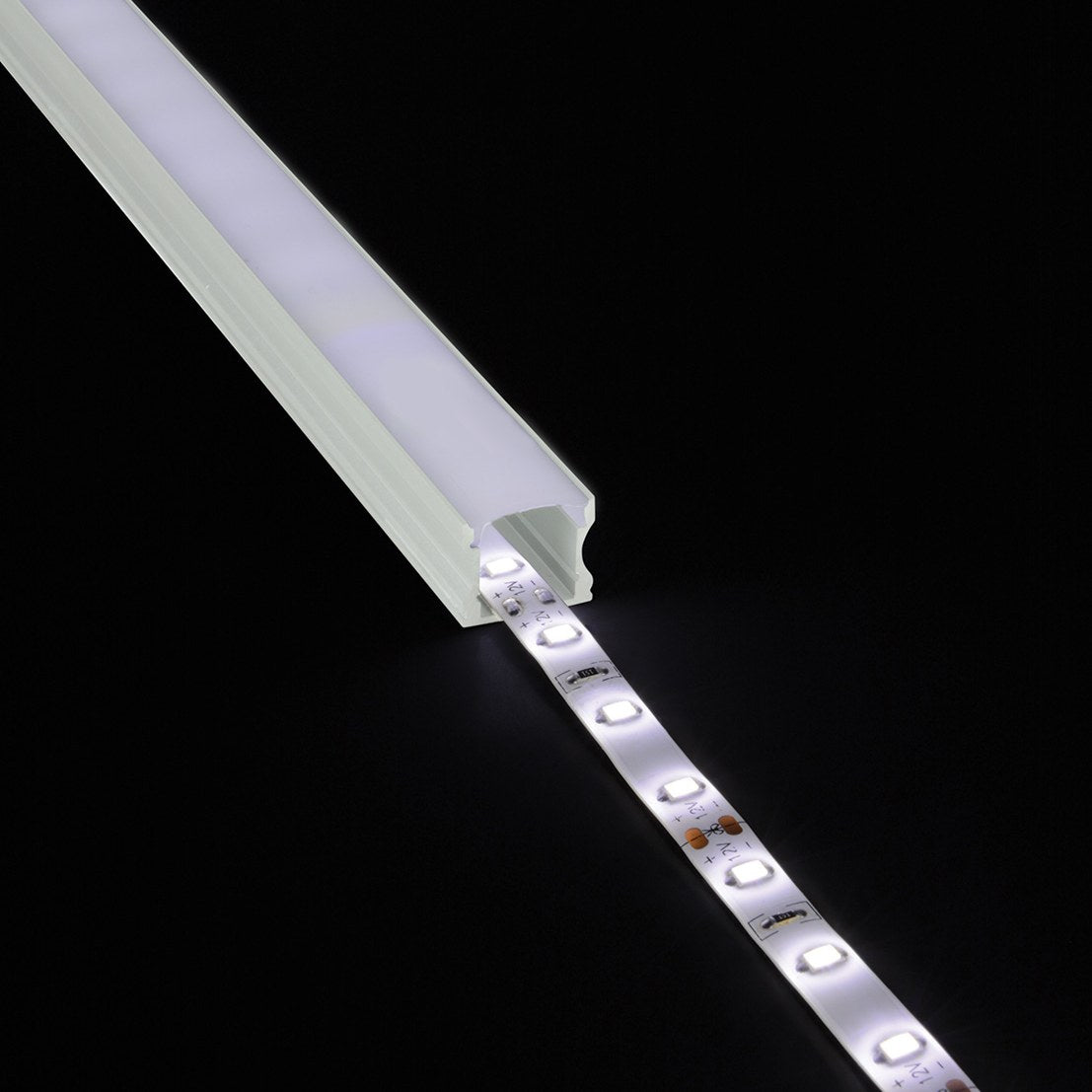 LYYT Tall Crown 1m aluminium surface mount LED profile by AVSL with illuminated LED tape emerging from the crowned diffuser channel on black.