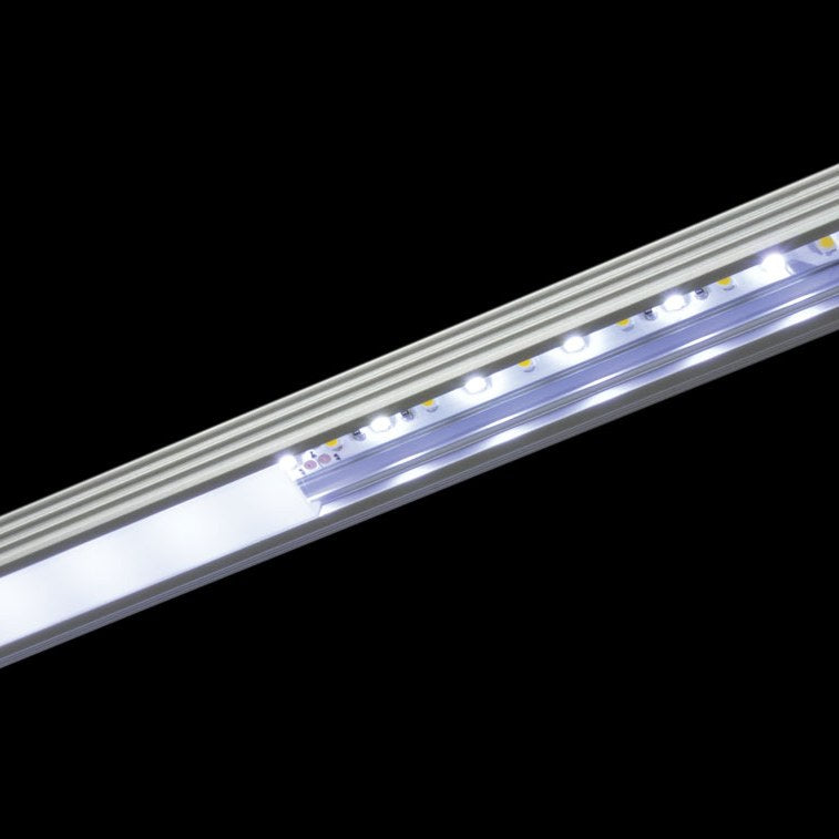 LYYT 45° surface mount LED corner profile by AVSL, aluminium extrusion with illuminated LED strip visible through the clear diffuser channel.