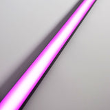 LYYT Tall Crown 1m black aluminium surface mount LED profile illuminated in pink, shown diagonally across a plain light grey background.