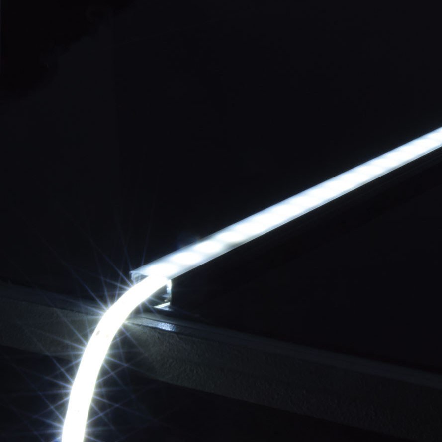 LYYT Wide Crown 1m surface mount LED profile by AVSL, illuminated in black aluminium with bright white diffused light along the crowned opal channel.