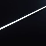 Illuminated LYYT Short Crown 2m surface mount LED profile by AVSL, shown as a bright diagonal line of light against a matte black background.