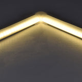 LYYT 90° Arc corner connector by AVSL joining two illuminated LED strip profiles at a right angle, showing the warm diffused light continuing across the bend.