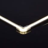 LYYT translucent polycarbonate corner connector by AVSL joining two illuminated LED profile sections at a 90-degree angle against a dark background.
