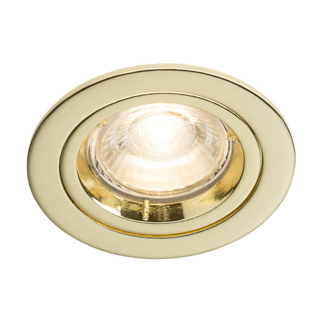 The GU10 Brass Recessed Fixed Twist & Lock Downlight showcases a shiny gold rim in a close-up view. When lit, it emits a bright white glow from the center. Crafted with a modern and minimalistic design, its brass die-cast finish elegantly enhances any interior space.