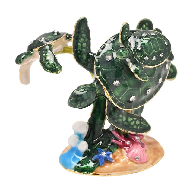 Coral metal trinket box with hinged shell lid, featuring enamel sea turtles, a baby turtle, starfish, seaweed, and coral details on a sandy base, shown on a white background.