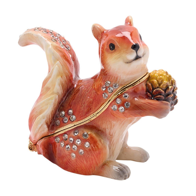 Red Squirrel and Pine Cone Hinged Metal Trinket Box in glossy brown with cream accents, holding a pine cone, decorated with clear crystals and a gold-tone rim on a white background.