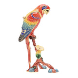 Macaw on Branch Metal Trinket Box with hinged lid, red-to-yellow body, green and blue wings, gold feather details, blue jewel accents, perched on a leafy branch.