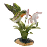 Hummingbird and Lily Metal Trinket Box with Base in glossy green, featuring a jewelled bird sipping from a pink-and-white lily on leafy stems, shown on a plain white background.