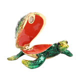 Sea Turtle Hinged Metal Trinket Box with Gold Trim in green, shown open with a jewelled shell lid, red enamel interior, and gold-edged flippers on a white background.