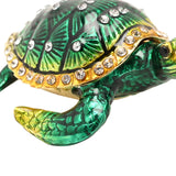 Sea Turtle Hinged Metal Trinket Box with Gold Trim in Green, close-up of domed shell with clear crystal accents and gold-edged rim, on a white background.
