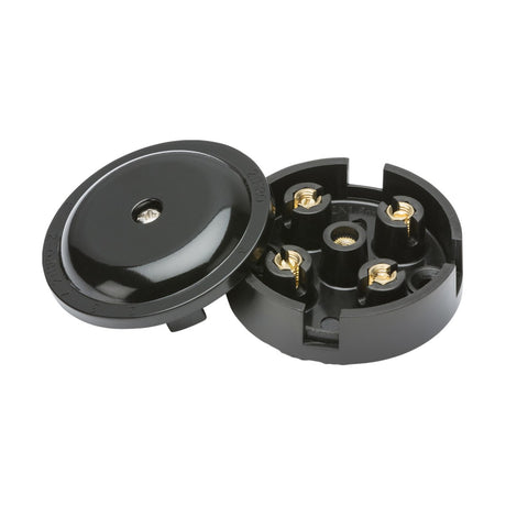 The 5A Junction Box 4-Terminal - Black (59mm) is a round electrical component crafted from thermoset resin, complete with a detachable lid. When the lid is removed, brass-colored screw connectors rated at 5A are visible for wiring. The shiny surface enhances the sleek appearance of this essential component.